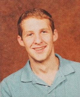 a young white man wearing a polo