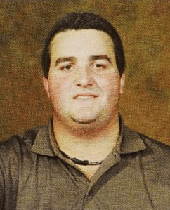 a young white man with dark hair wearing a polo