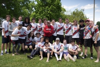 a group of young people in ultimate frisbee uniforms on a sunny day