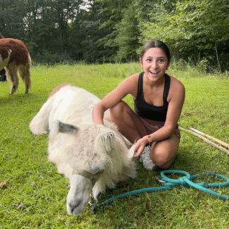 a young woman with short brown hair next to a cow