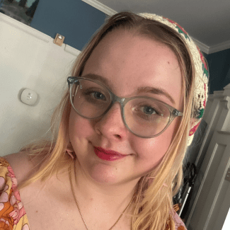 a young woman with blonde hair wearing a bandana and glasses