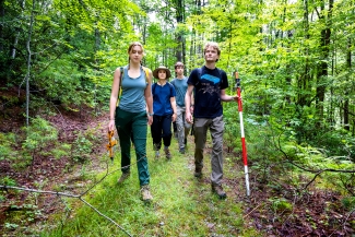 a group of young people hiking in the woods