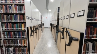 Rows of books and the kind of shelves that you can move with a steering wheel