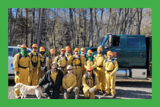 Incarcerated firefighters wearing yellow jumpsuits