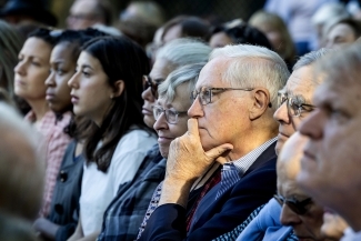 Members of the audience solemnly listen to the ceremony