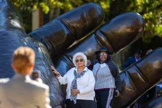 Participants pose with the sculpture for a photo