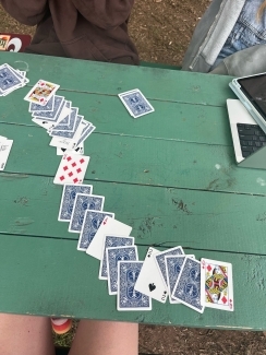 a deck of cards on a green picnic table
