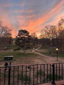 a sunset over a college quad