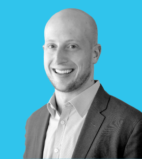 Young smiling man with white teeth and a shaved head