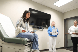 a young woman sits in a hospital room