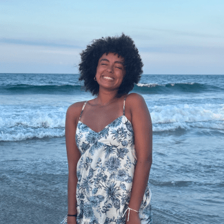 a headshot of Aiyana Thornton ’29 on the beach