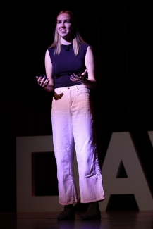 Natalie speaking on stage at 50 years of Coeducation