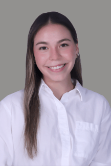 A young woman with long brown hair and a white button down