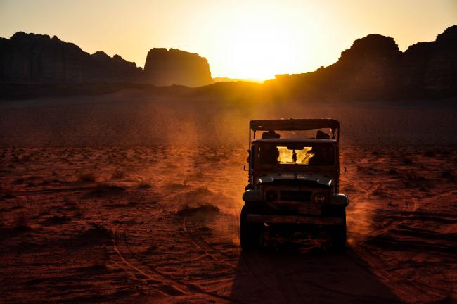 Jeep driving through the desert of Wadi Rum, Jordan
