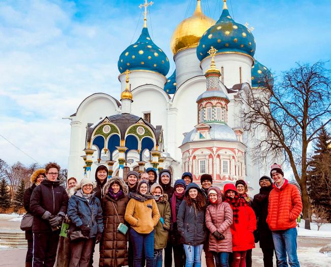Students, faculty and staff in Russia stand near Russian Church
