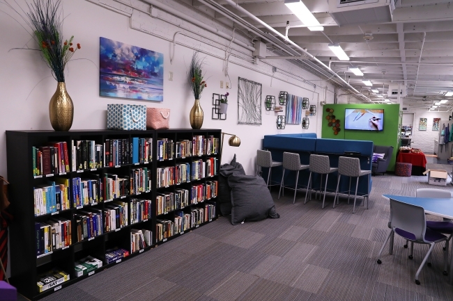 Shot of bookshelf with textbooks and workstations