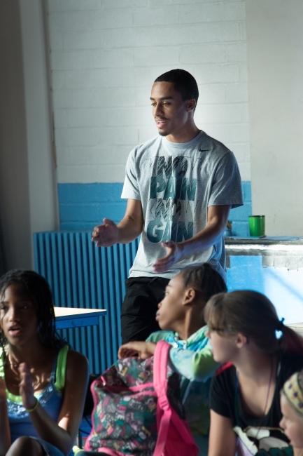Freedom Schools volunteer sings to kids