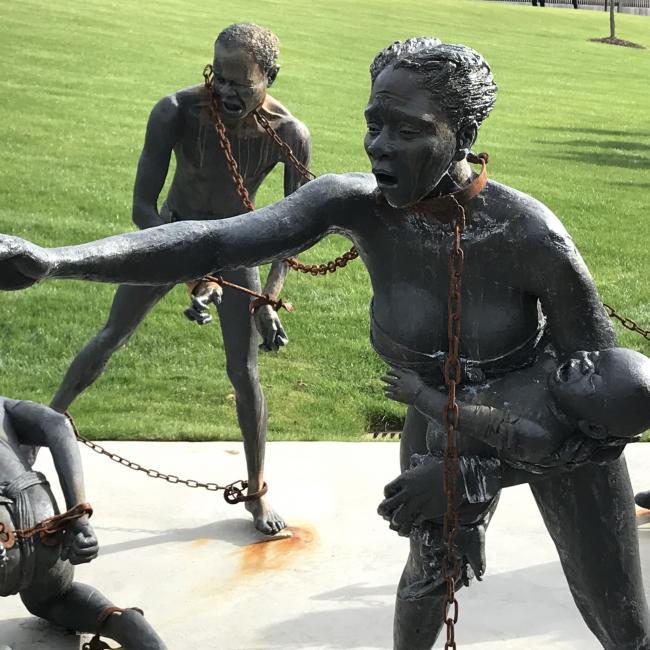 Monument of chained persons trying to free themselves