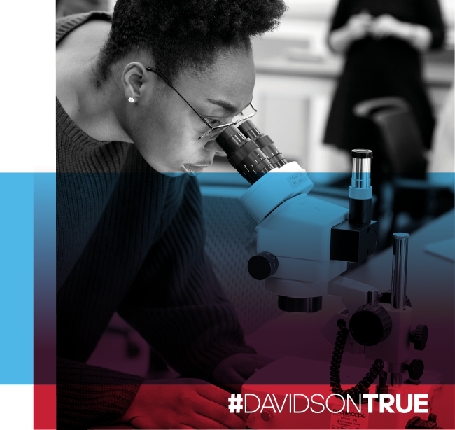 DAVIDSONTRUE student looking through a microscope