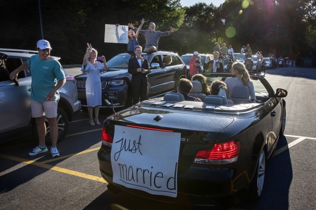 Caroline and Tyler back of car with 'just married' sign 