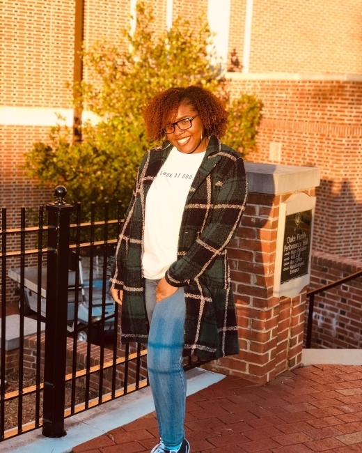 smiling woman posing for a sunlight pic in front of union
