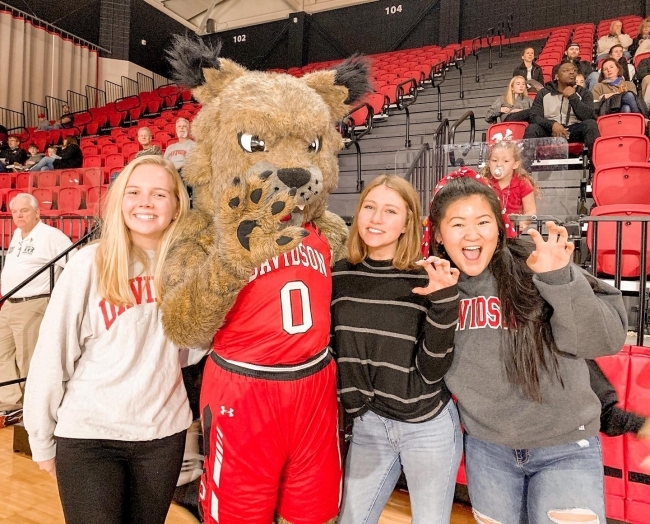 spirited Davidson students pose with mascot