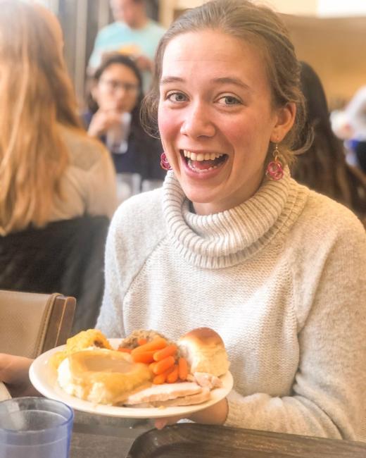 student is excited to eat her commonsgiving meal