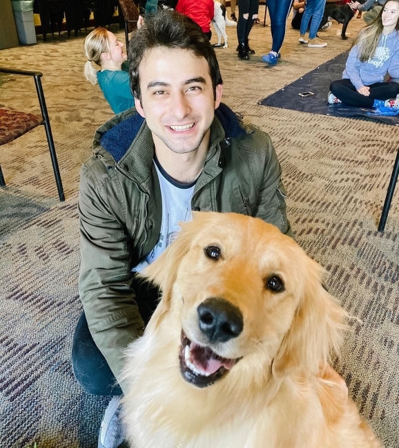 students pet dogs during puppy day