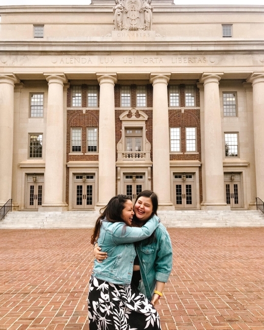 Two women embrace in matching denim jackets