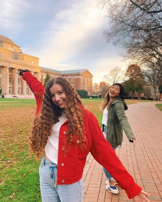 two friends smile together for a photo