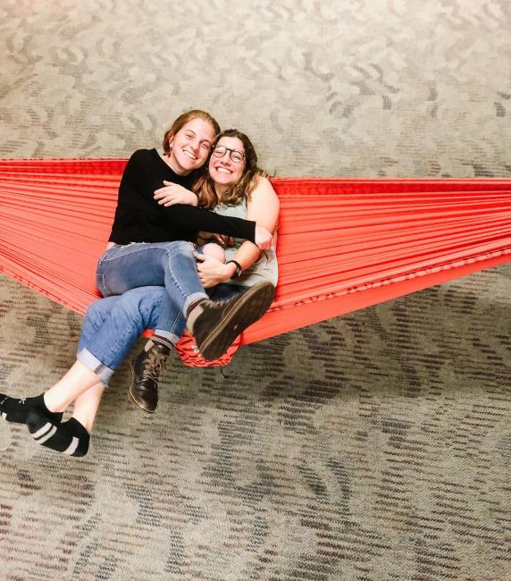 freinds cuddle together for a picture in a hammock