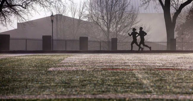 Runners make their way around the Irwin Belk Track on a brisk January morning. 