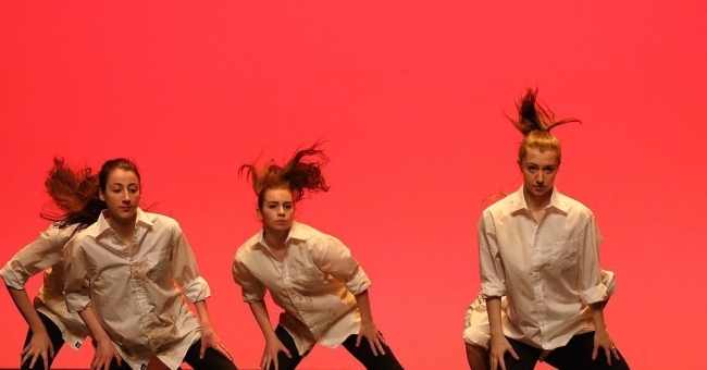 dance performance with red backdrop