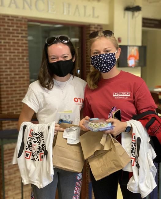 Students wearing masks with Dining Services merchandise