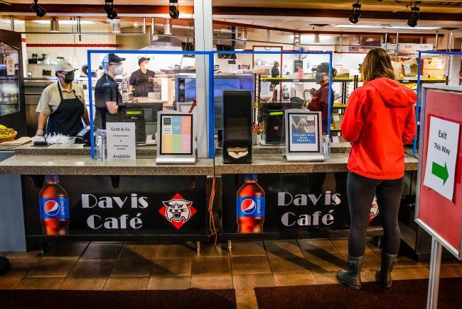 Student Checks out at Davidson's Davis Café with employees working in the background