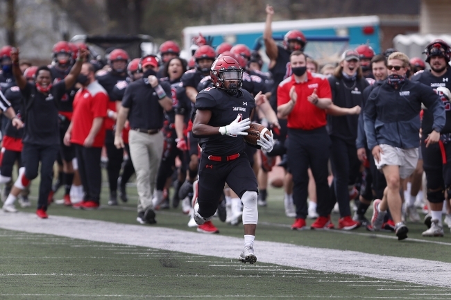 Davidson Football Player Gains Yards with Full Team Cheering Them on in Background