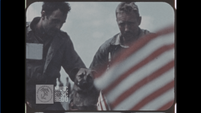 two soldiers at American flag memorial