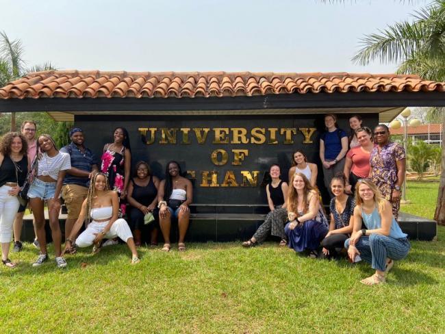 Students pose by University of Ghana sign 