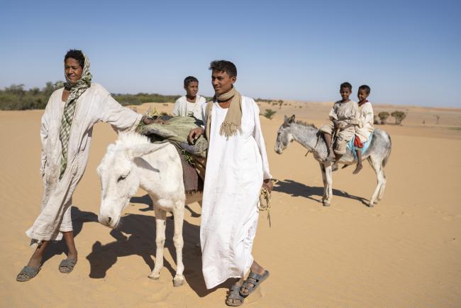 boys on donkeys in the desert photo by Matt Stirn