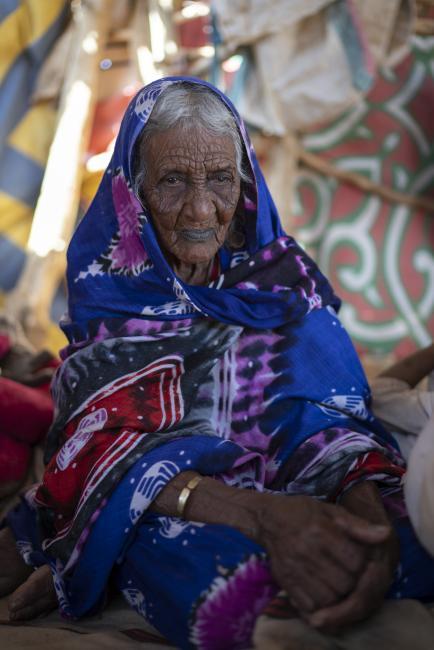 Photo by Matt Stirn - Medina, a 100-year-old Nomad sits in her canvas tent deep in Sudan’s Bayuda desert