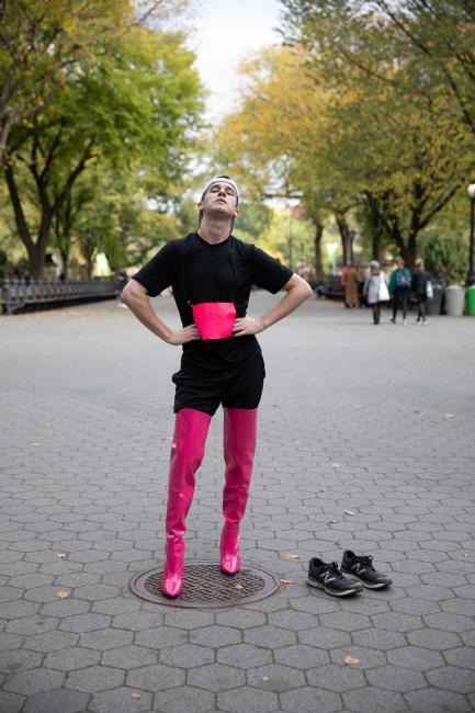 Davidson College alum Dan Van Note '14 in hot pink thigh-high boot heels with sneakers on ground for 2019 Endurance Queen performance