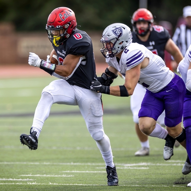 Opposing Player Grabs onto Davidson Player, Holding the Ball