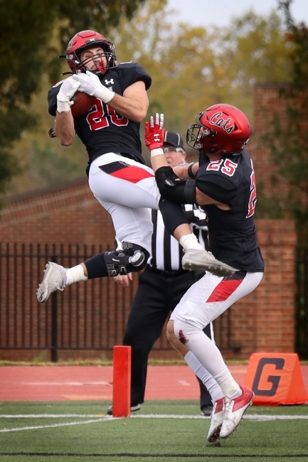 Football Players Jumping in Air with Ball in Hand