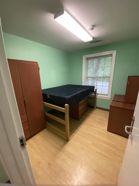 Flowe Bedroom with bed, armoire, and desk