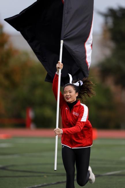 Cheerleader Runs Holding Davidson Flag