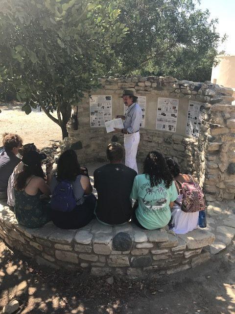 Mike Toumazou teaching under an olive tree