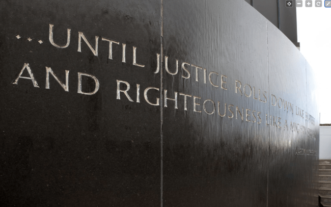 An embossed wall at the Civil Rights Memorial showing words "...Until Justice.." 