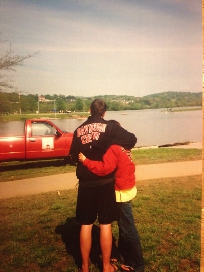 The back sides of David in Davidson hoodie and Andrea looking out at lake