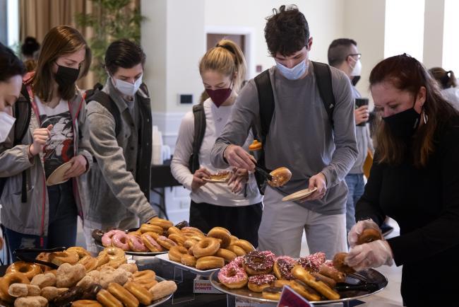 Random Acts of Kindness Students eating donuts in Lilly Gallery