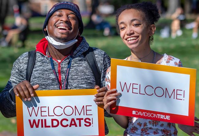 Students holding welcome wildcats signs
